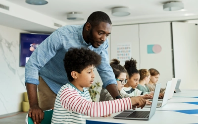 Teacher helping students in a classroom